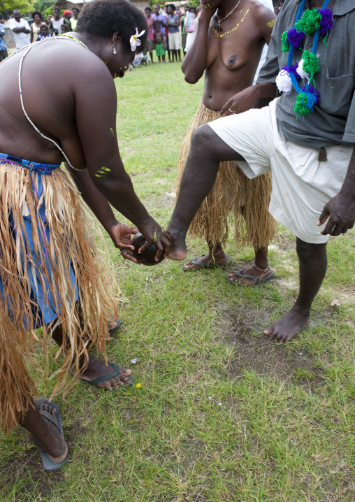 Woman welcoming visitors by washing their feet, Autonomous Region of Bougainville, Bougainville, Papua New Guinea