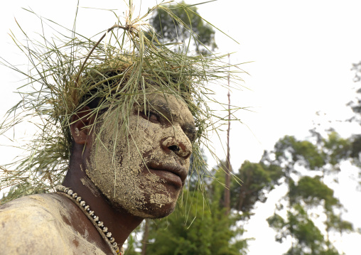 Portrait of a Chimbu tribe man with vegetal headwear during a sing sing, Western Highlands Province, Mount Hagen, Papua New Guinea