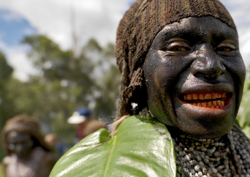 Portrait of a Emira tribe woman with betel smile during a Sing-sing ceremony, Western Highlands Province, Mount Hagen, Papua New Guinea