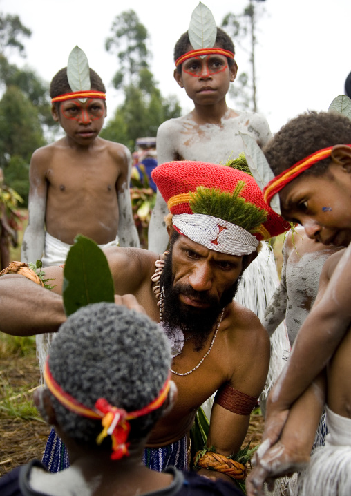 Early morning makeup for the children during a  sing sing, Western Highlands Province, Mount Hagen, Papua New Guinea