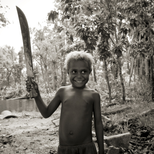 Boy holding a long knife, New Ireland Province, Laraibina, Papua New Guinea