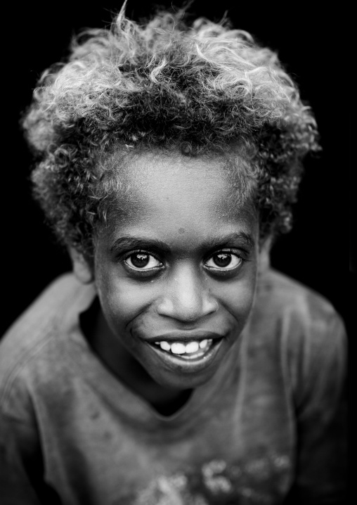 Portrait of a smiling boy with blonde hair, New Ireland Province, Langania, Papua New Guinea