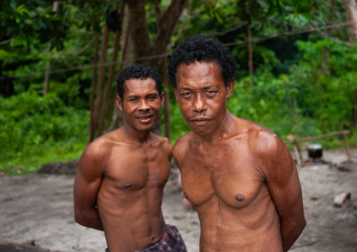 Portrait of shirtless men, Milne Bay Province, Trobriand Island, Papua New Guinea