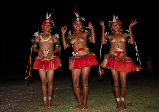 Portrait of topless tribal women in traditional clothing dancing, Milne Bay Province, Trobriand Island, Papua New Guinea