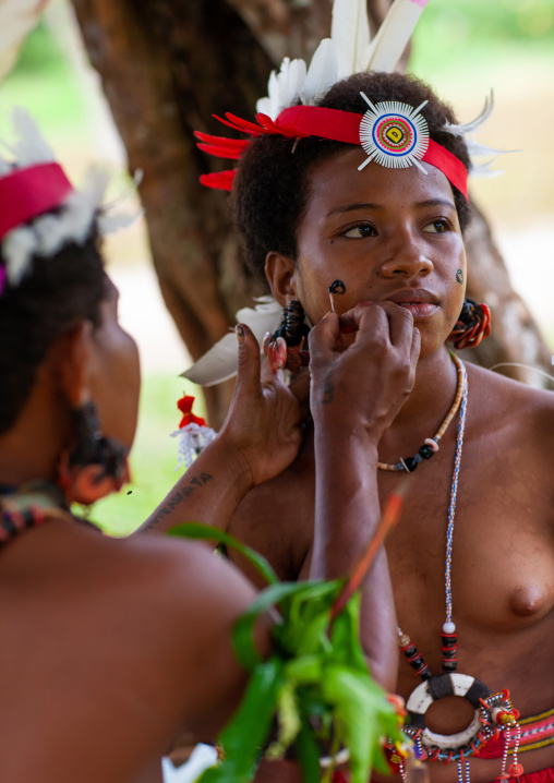 Tribal woman preparing for a ceremony, Milne Bay Province, Trobriand Island, Papua New Guinea