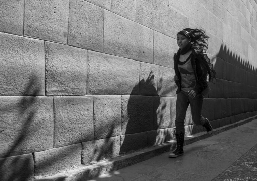 Girl Running In Front Of A Stone Wall, Cuzco, Peru
