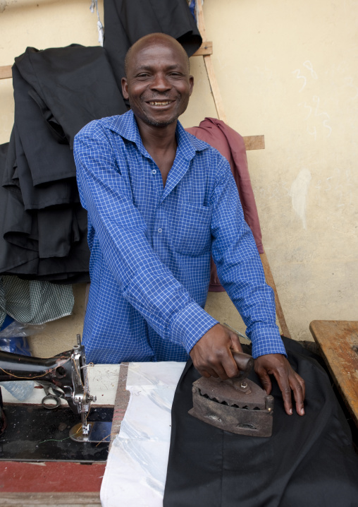 Rwandan man ironing in the market, Lake Kivu, Gisenye, Rwanda