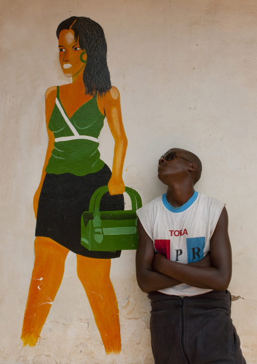 Rwandan man in front of a shop mural, Kigali Province, Kigali, Rwanda