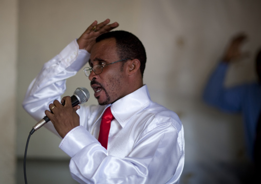 Rwandan man singing during a sunday mass in a church, Kigali Province, Kigali, Rwanda
