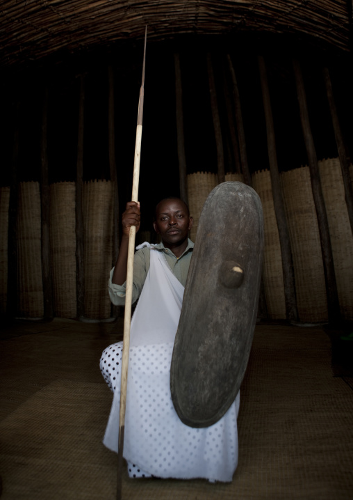 Traditional intore dancer with a shield during a folklore event in a village of former hunters, Lake Kivu, Ibwiwachu, Rwanda