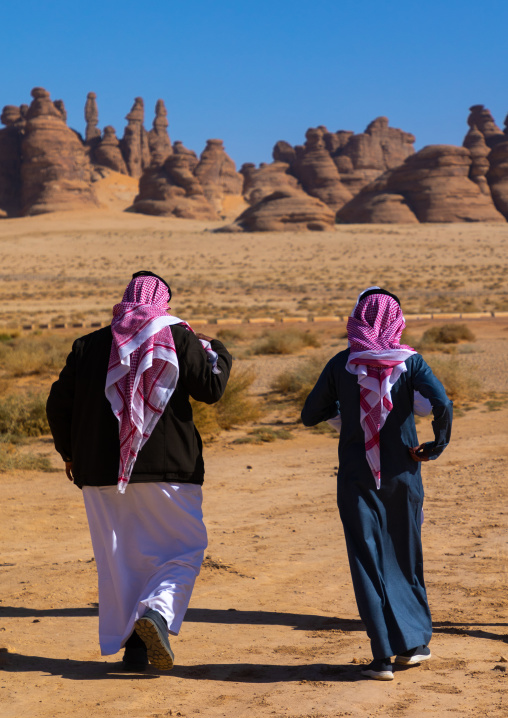 Rear view of saudi men in Madain Saleh, Al Madinah Province, Alula, Saudi Arabia