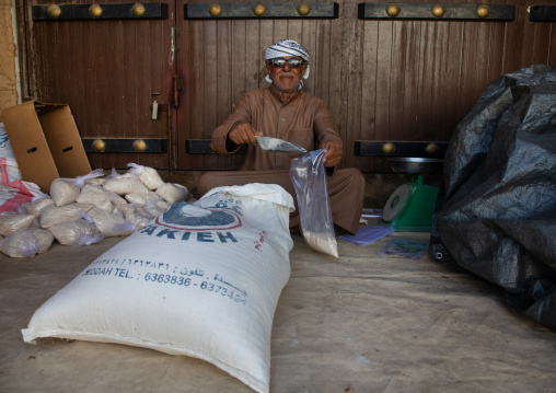Saudi old man packing date powder in bags, Najran Province, Najran, Saudi Arabia