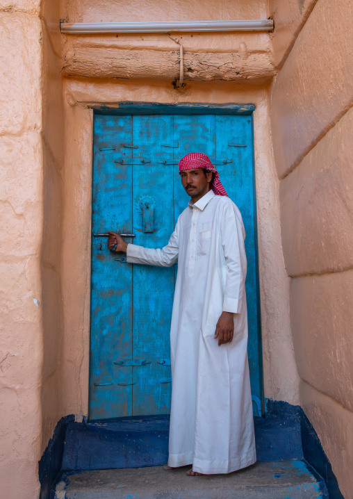 Saudi man at the entrance of his traditional house, Najran Province, Najran, Saudi Arabia