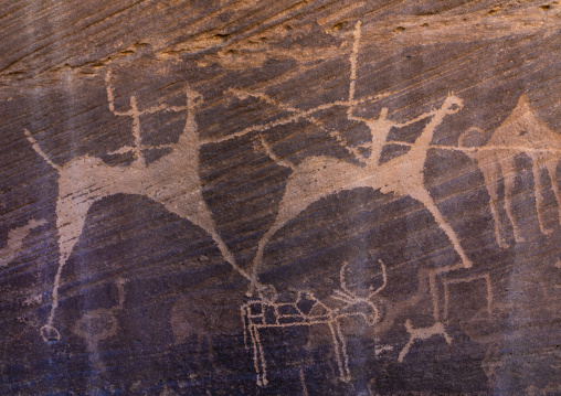 Petroglyphs on a rock depicting men hunting on horses, Najran Province, Minshaf, Saudi Arabia