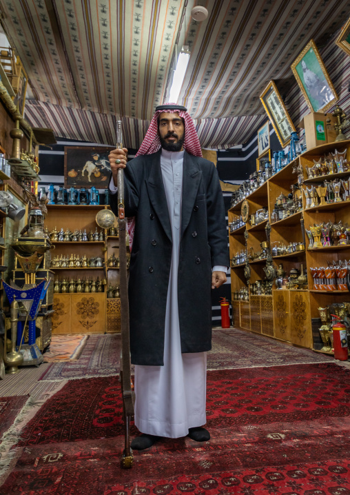 Saudi man buying a traditional sword in a shop, Al-Bahah region, Al-Bahah, Saudi Arabia