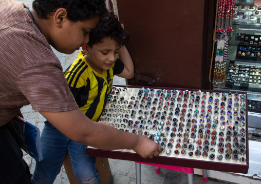 Saudi children looking for rings in a shop, Mecca province, Jeddah, Saudi Arabia