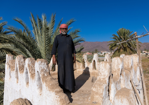 Saudi man standing on the terrace of his mud house, Najran Province, Najran, Saudi Arabia