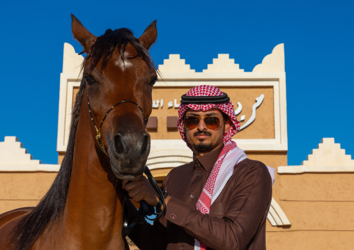 saudi man with his Arabian horse in Alhazm stud, Najran Province, Khubash, Saudi Arabia