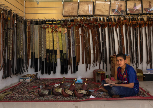 Saudi boy selling belts and janbiya daggers, Najran Province, Najran, Saudi Arabia