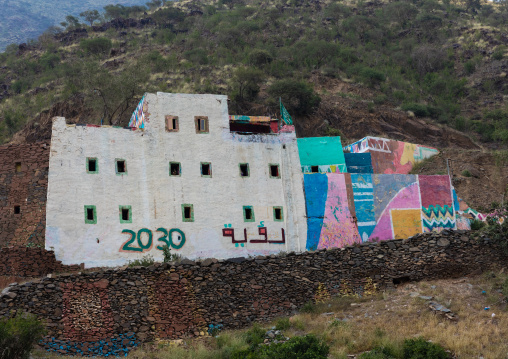 Old traditional house with 2030 logo on the facade, Asir province, Rijal Alma, Saudi Arabia