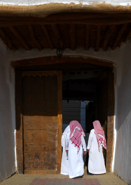 Saoudi men entering the old fort, Najran Province, Najran, Saudi Arabia