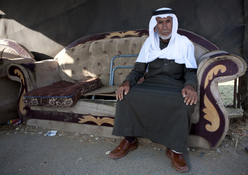 Portrait of a saudi man sit on an old sofa, Najran Province, Najran, Saudi Arabia