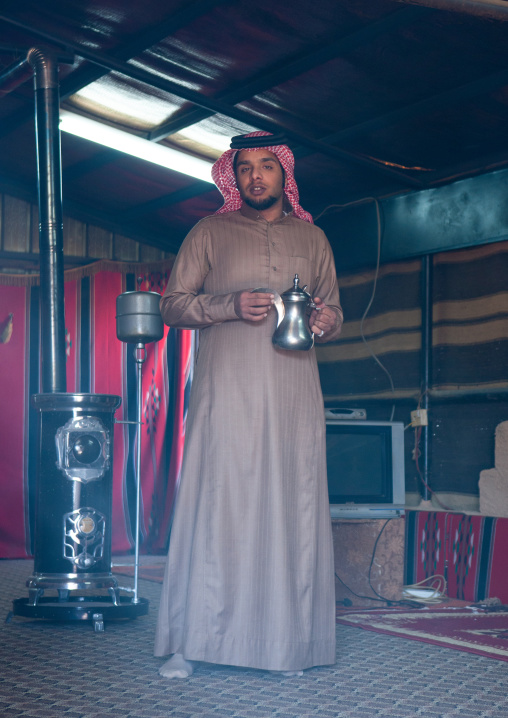 Bedouin under a tent in the desert serving coffee, Al-Jawf Province, Sakaka, Saudi Arabia