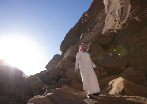 Saudi man walking in the rocks, Al Madinah Province, Alula, Saudi Arabia