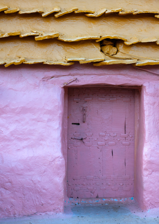 Pink door of a traditional clay and silt homes in a village, Asir Province, Aseer, Saudi Arabia
