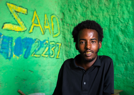 Young somali man in a shop with green walls, Sahil region, Berbera, Somaliland