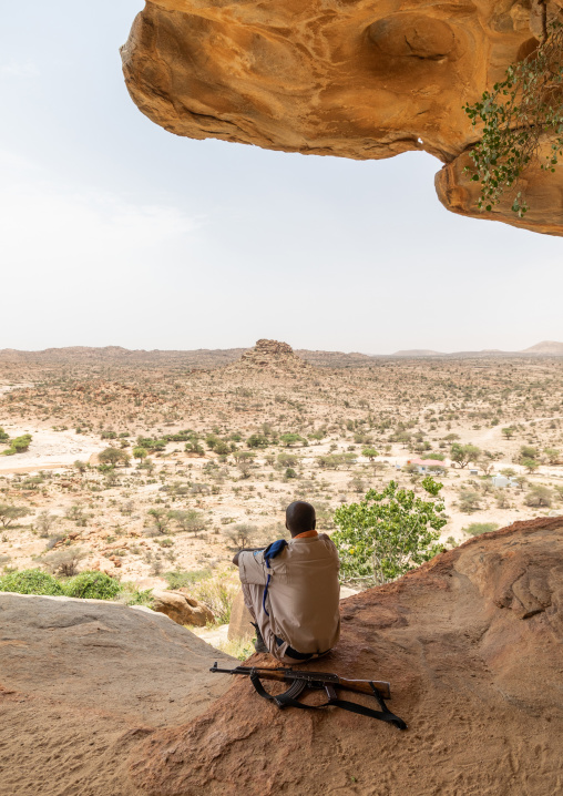 Somali soldier looking at the landscape of the laas geel area, Woqooyi Galbeed, Laas Geel, Somaliland