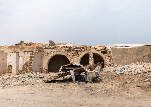 Rusty car in front of a former ottoman house in ruins, Sahil region, Berbera, Somaliland