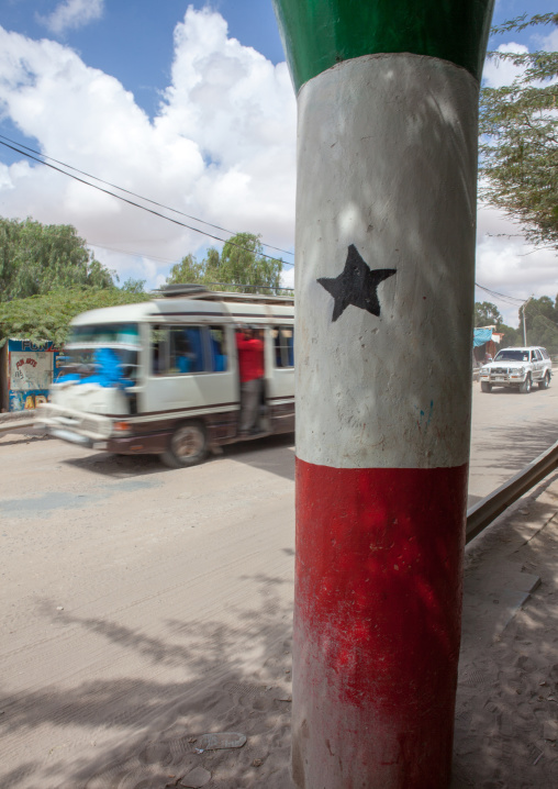 Bus passing in front of a pilar with the national flag, Woqooyi Galbeed region, Hargeisa, Somaliland
