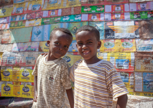 Two somalis boys in front of a house made of recycled stuff, North-Western province, Berbera, Somaliland