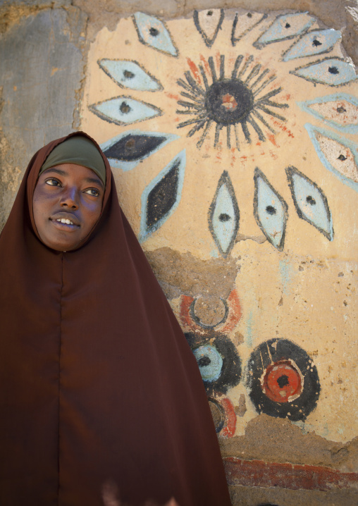 Young Woman Leaning Against A Painted Wall, El Sheikh, Somaliland