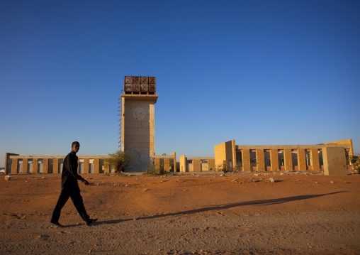 A Man Walking Through The Ruins Of The Burao Technology Institute At Sunset, Burao, Somaliland
