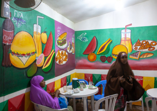 Somali women inside a restaurant with decorated walls, Woqooyi Galbeed region, Hargeisa, Somaliland