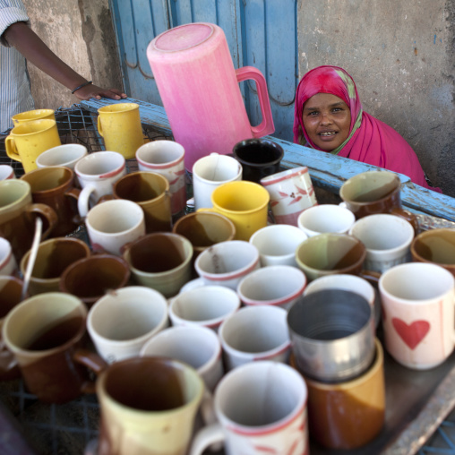 A Woman Sat Behind A Tray Of Dirty Mugs In A Cafe, Boorama, Somaliland