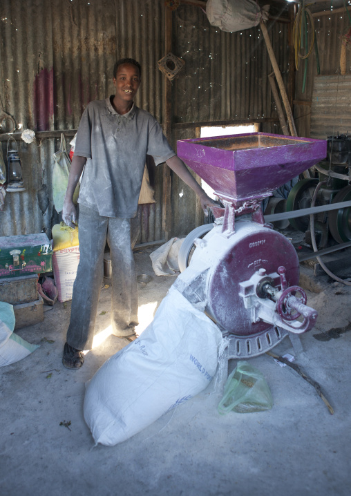 A Teenage Boy Using An Electric Mill In A Flour Workshop, Boorama, Somaliland