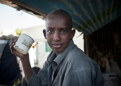 Portrait Of A Boy Holding An Enamel Mug And Wearing A Blue Shirt, Boorama, Somaliland