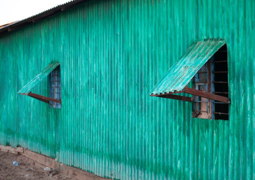 A run down metal house made from corrugated iron painted in green, Awdal region, Zeila, Somaliland