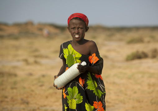 A Nomad Woman Carrying A Bottle Of Camel Milk In The Desert, Berbera Area, Somaliland