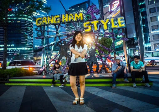 North korean teen defector in front of a gangnam style logo dancing like psy, National capital area, Seoul, South korea