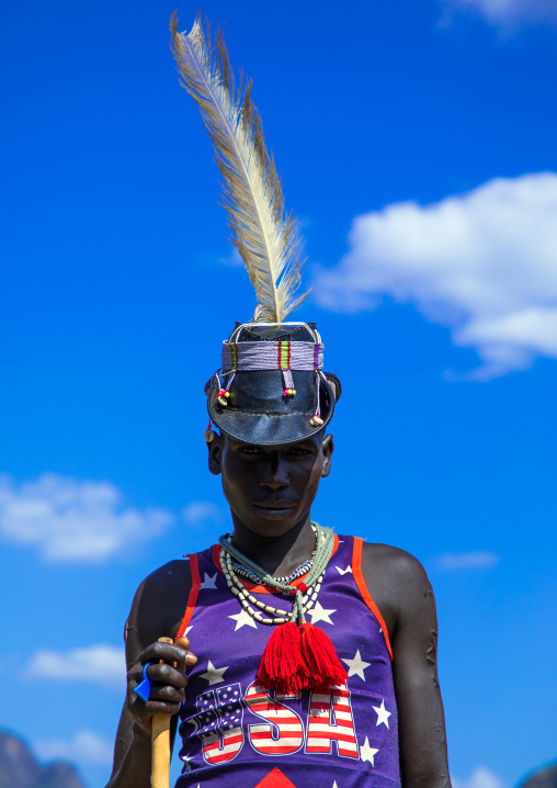 Larim tribe man with american tshirt and a hat, Boya Mountains, Imatong, South Sudan