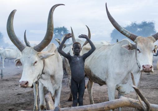 A Mundari tribe man mimics the position of horns of his favourite cow, Central Equatoria, Terekeka, South Sudan