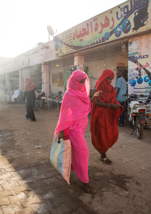 Sudanese women walking in the street in colorful clothes, Kassala State, Kassala, Sudan
