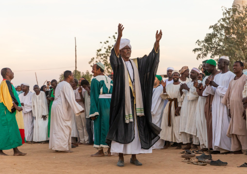 Man with arms raised leading the friday sufi celebration at sheikh Hamad el Nil tomb, Khartoum State, Omdurman, Sudan