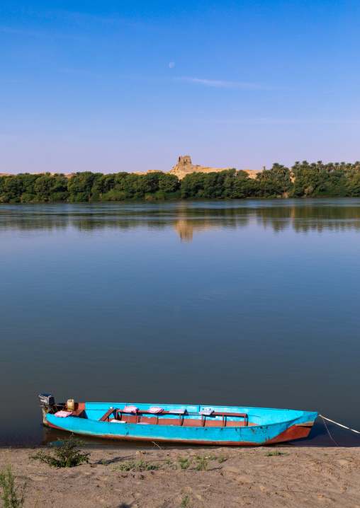 Plam trees and boat on the bank of river Nile, Northern State, El-Kurru, Sudan
