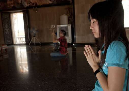 Women praying in a temple, Bangkok, Thailand