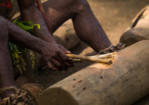 Small Nambas tribesman beating on a slit gong drum during the palm tree dance, Malekula island, Gortiengser, Vanuatu